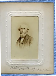 Bust Portrait of a Bearded Man with Curly Hair Wearing a Suit and Turned Slightly to the Left